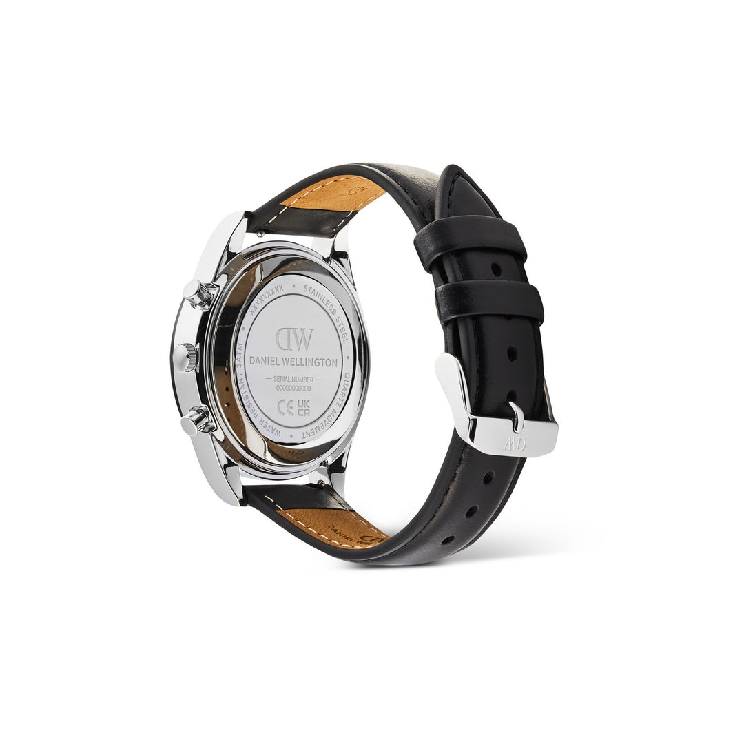 Daniel Wellington men's watch shown from the back, featuring a polished silver-tone stainless steel case and a black leather strap with tan stitching and a silver buckle.