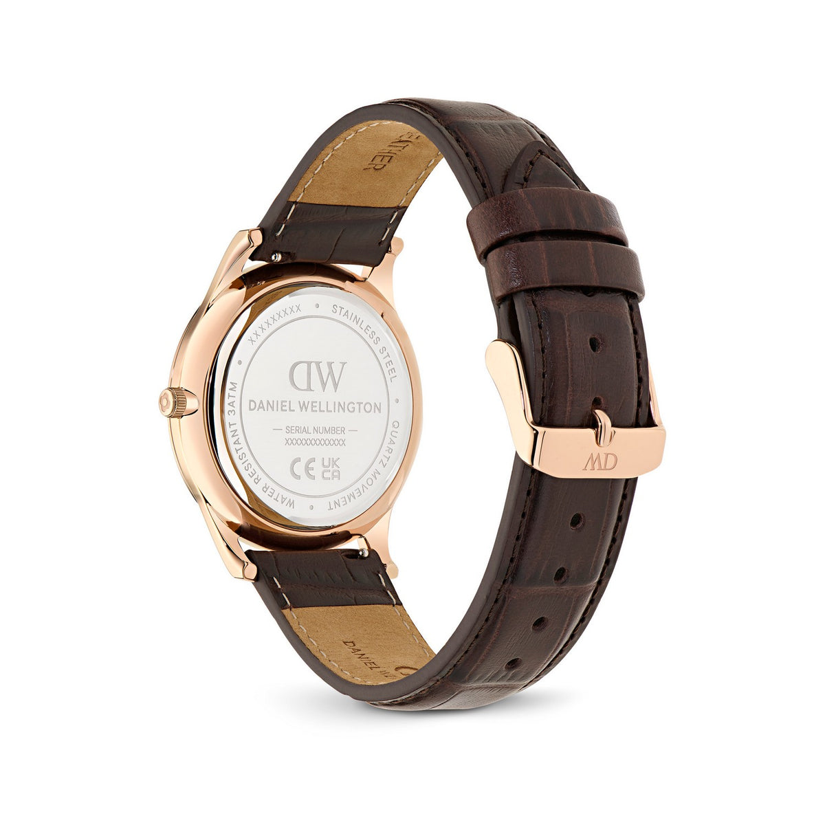 Daniel Wellington watch with a rose gold case and a dark brown leather strap, showing the back of the watch with a clear crystal and the branded clasp on a white background.