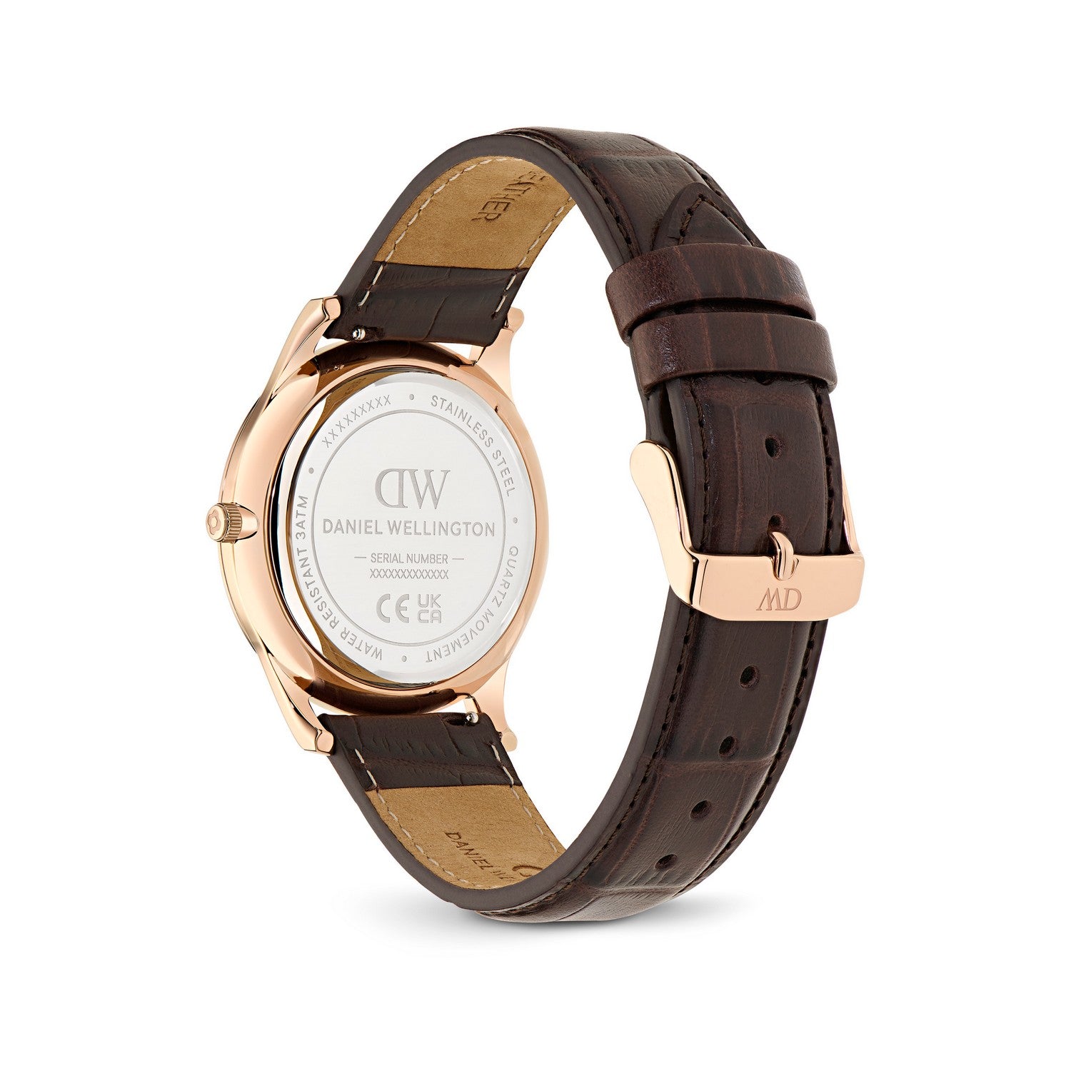 Daniel Wellington watch with a rose gold case and a dark brown leather strap, showing the back of the watch with a clear crystal and the branded clasp on a white background.