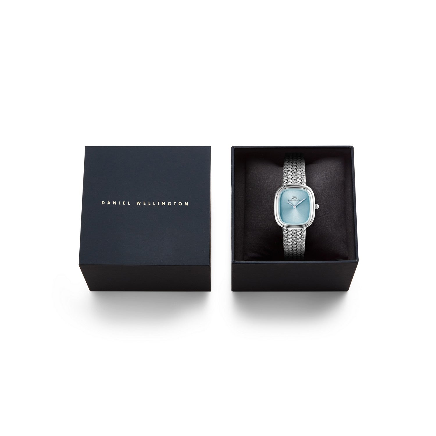 Daniel Wellington silver-tone watch with a light blue dial, presented in an open black gift box next to its closed lid on a white background.