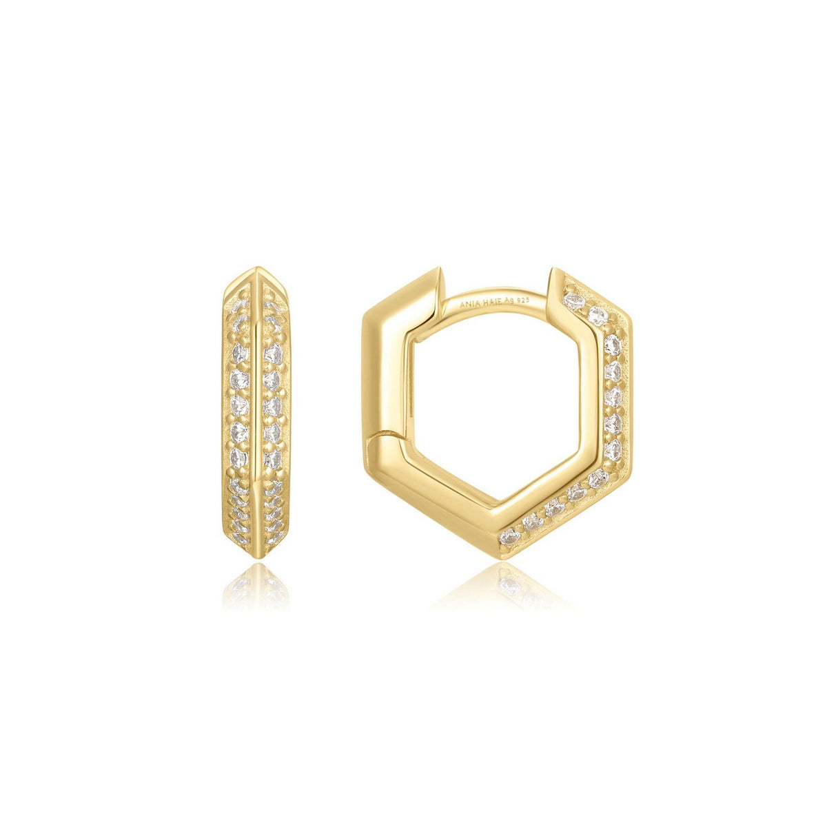 Gold hexagonal hoop earrings with embedded stones on a white background