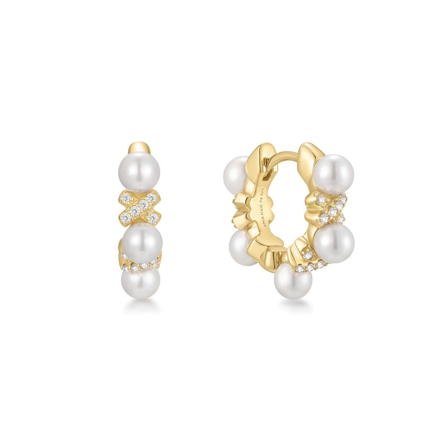 Gold hoop earrings with pearls on a white background
