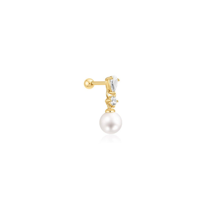 Gold earring with a pearl and clear gemstone on a white background