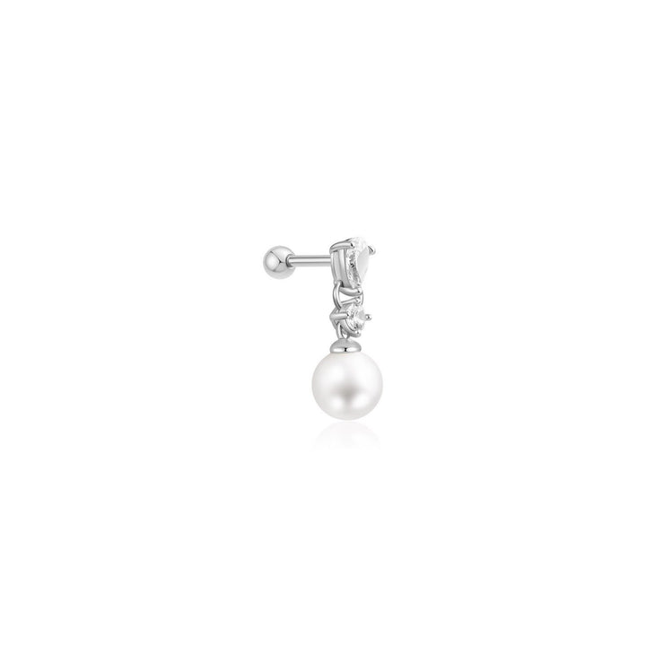 Single earring with pearl and clear gemstone on a white background