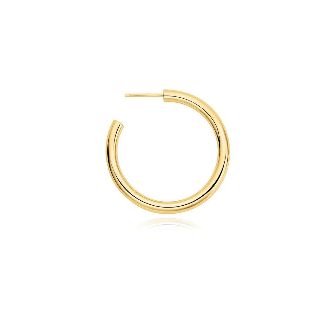 Gold hoop earring on a white background