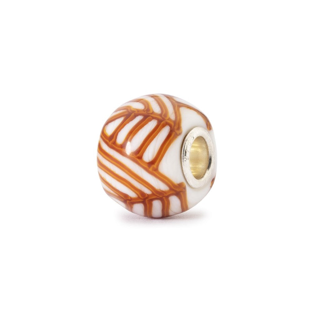 Decorative bead with orange and white pattern on a white background