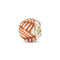 Decorative bead with orange and white pattern on a white background