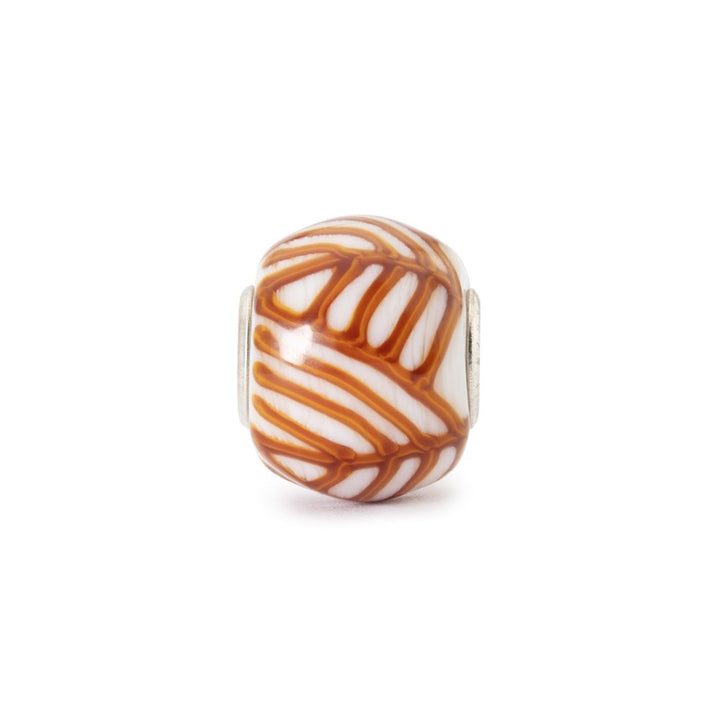 Decorative bead with brown and white pattern on a white background