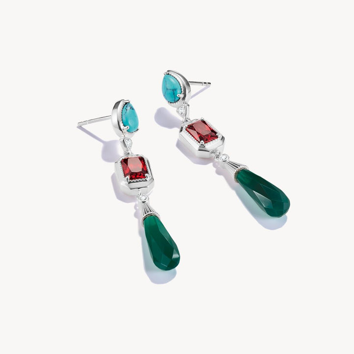 Pair of earrings with gemstones on a white background
