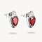 Pair of silver earrings with red gemstones on a white background