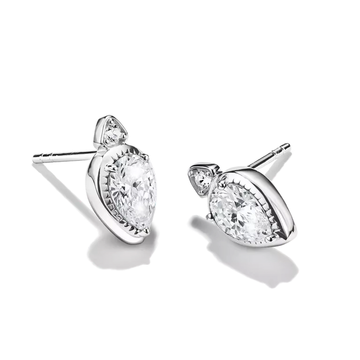 A pair of silver-toned pear-cut stud earrings with clear gemstones, shown on a clean white background with soft shadows.