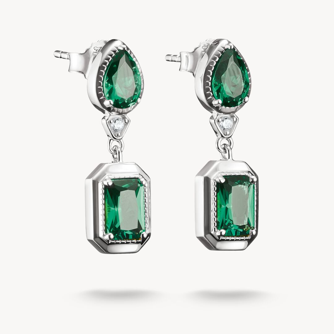 Pair of emerald earrings on a white background