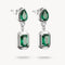 Pair of emerald earrings on a white background