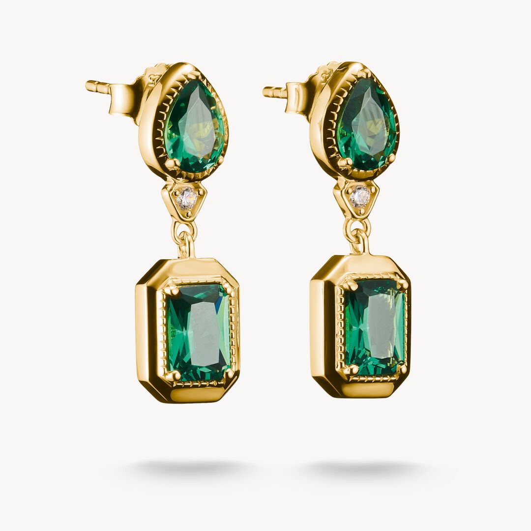 Gold earrings with green gemstones on a white background