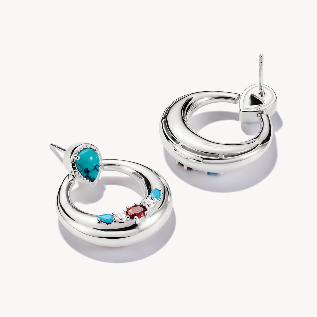 Silver hoop earrings with gemstones on a white background
