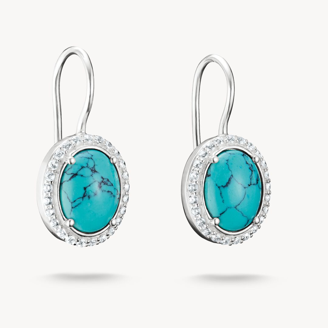 Turquoise earrings with silver hooks on a white background