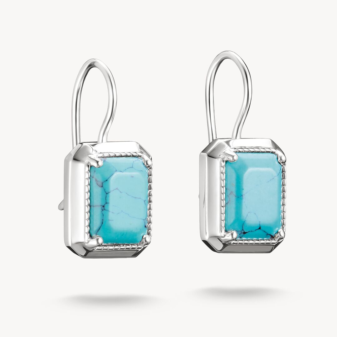 Pair of earrings with turquoise stones on a white background