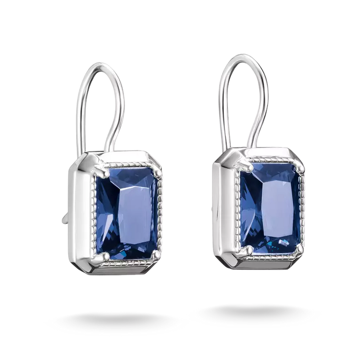 A pair of silver drop earrings featuring rectangular blue gemstones in a bezel setting with a delicate border, shown against a plain white background.
