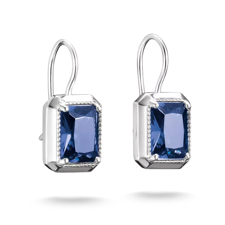 A pair of silver drop earrings featuring rectangular blue gemstones in a bezel setting with a delicate border, shown against a plain white background.