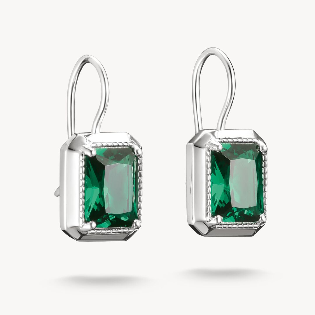 Pair of silver earrings with green gemstones on a white background