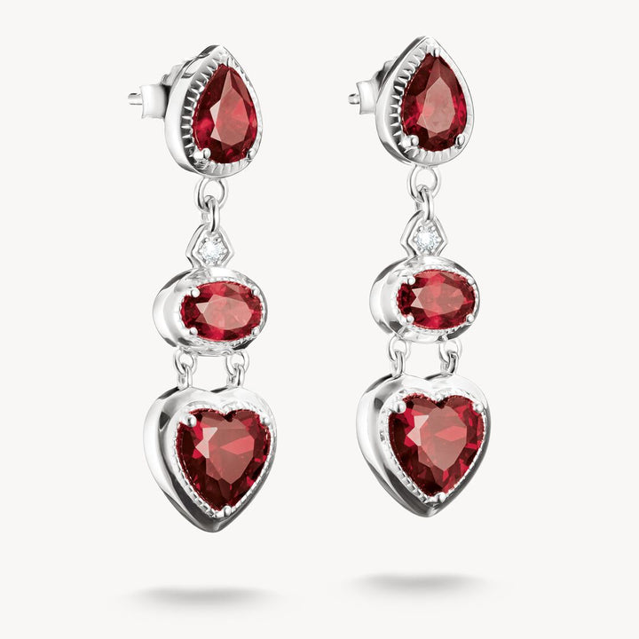 Pair of earrings with red gemstones on a white background