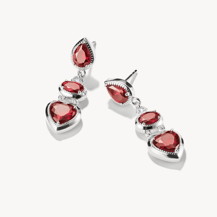 Pair of red heart-shaped earrings on a white background