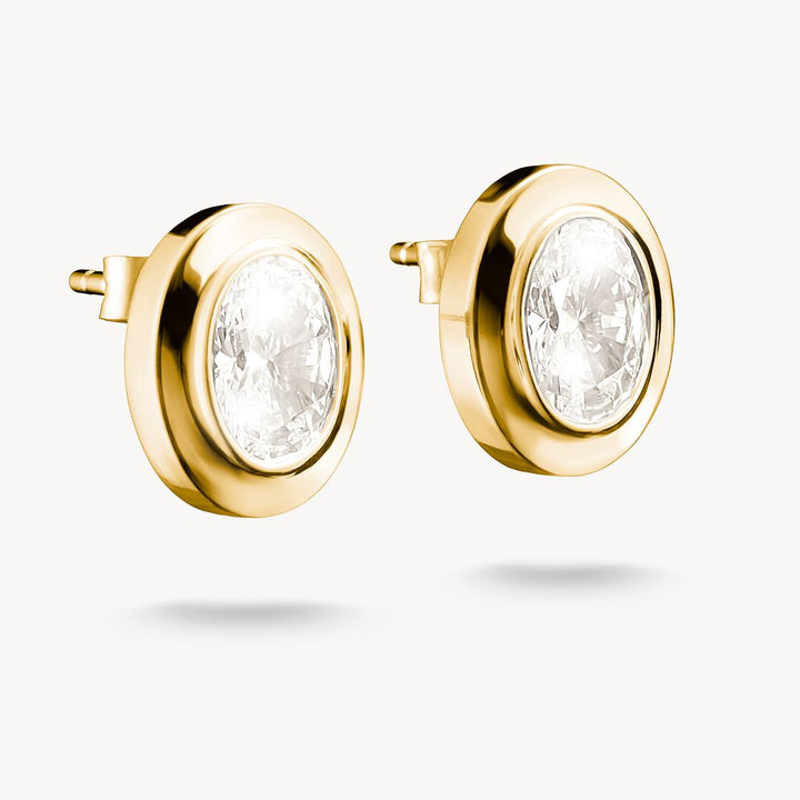 Gold earrings with clear gemstones on a white background