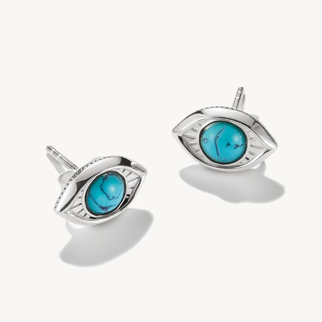 Pair of silver earrings with turquoise stones on a white background