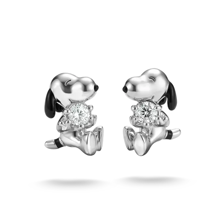Silver dog-shaped earrings with clear gemstones on a white background