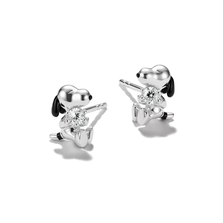 Silver dog-shaped earrings with clear gemstones on a white background