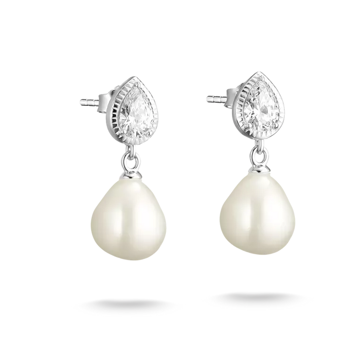 A pair of silver stud earrings featuring a teardrop-shaped clear crystal in a beaded halo setting with a dangling baroque pearl below, shown on a white background with soft drop shadows.
