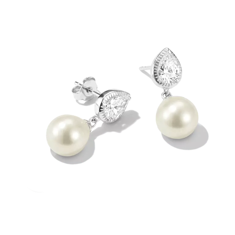 A pair of silver drop earrings featuring pear-cut clear stones and round white freshwater pearls, displayed on a clean white background.