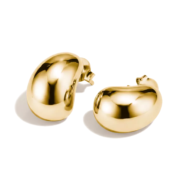 A pair of polished gold bean-shaped stud earrings on a clean white background.