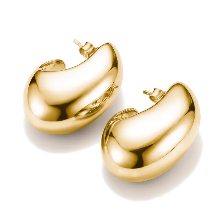 A pair of polished gold bean-shaped hoop earrings on a clean white background.