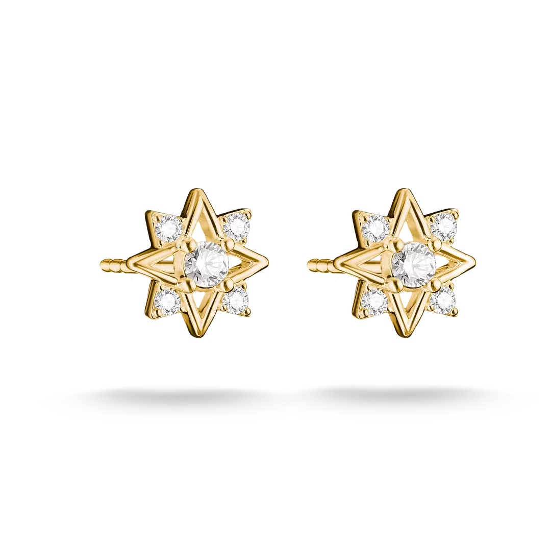 A pair of gold starburst stud earrings with clear round-cut gemstones, shown on a clean white background with soft shadows.