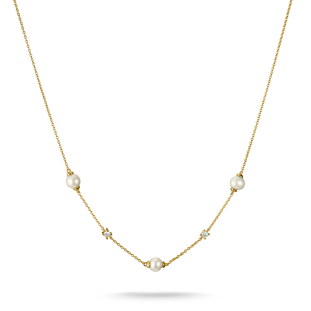 A delicate gold necklace featuring three white freshwater pearls and three small clear crystal clusters spaced along the chain, displayed on a clean white background.