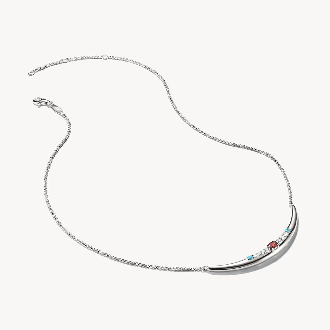 Silver necklace with small colored stones on a white background