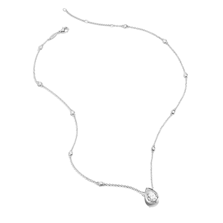 A delicate silver-toned necklace featuring a teardrop-shaped pendant set with a clear gemstone, accented by small bead details along the chain, shown on a plain white background.