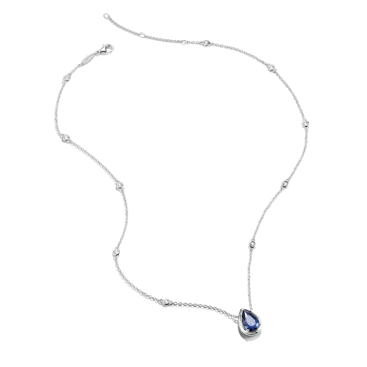 A delicate silver-toned necklace featuring a teardrop-shaped blue gemstone pendant, displayed on a clean white background.