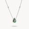 Silver necklace with a green teardrop pendant on a white background