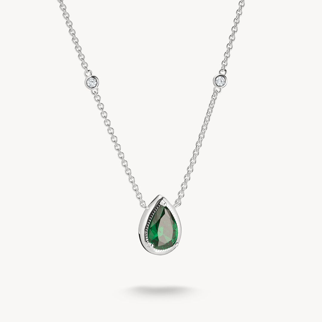 Silver necklace with a green teardrop pendant on a white background