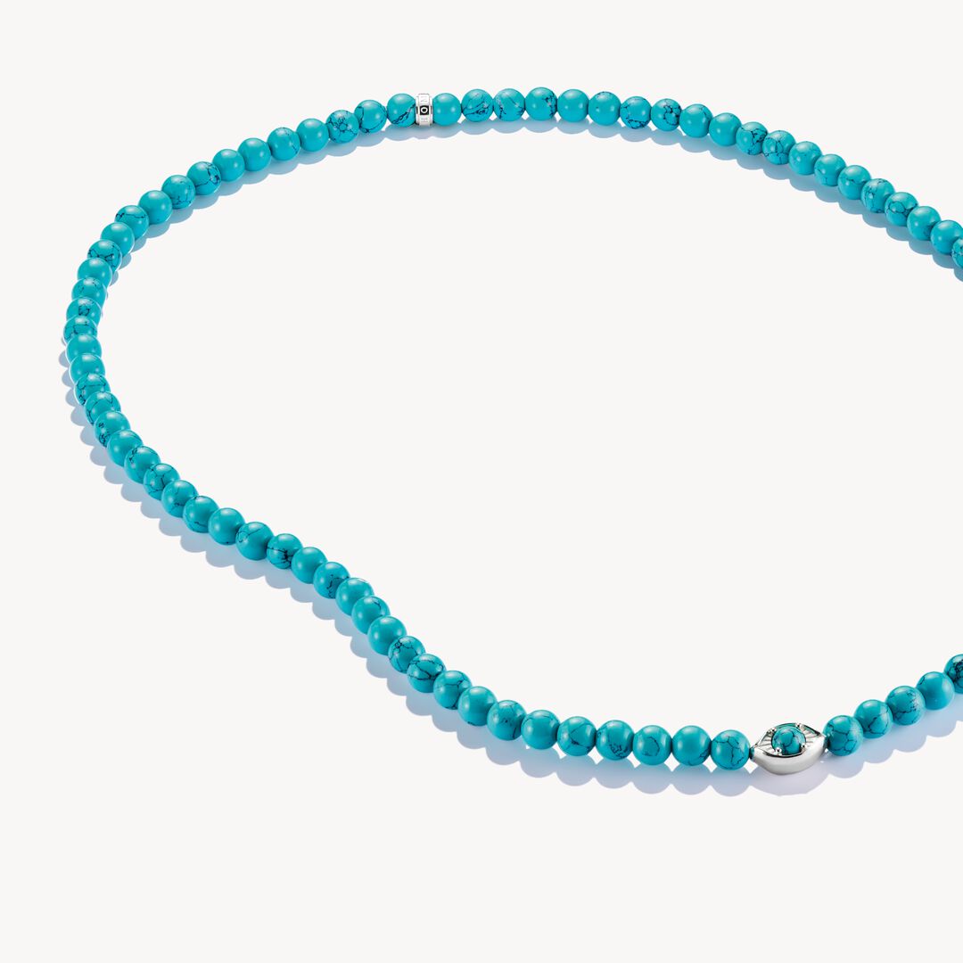 Turquoise beaded necklace with a silver clasp on a white background
