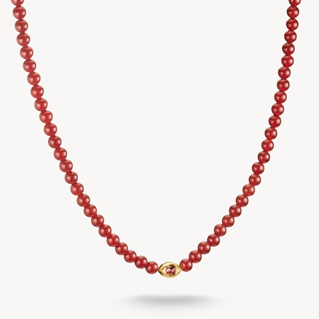 Red beaded necklace with a gold clasp on a white background