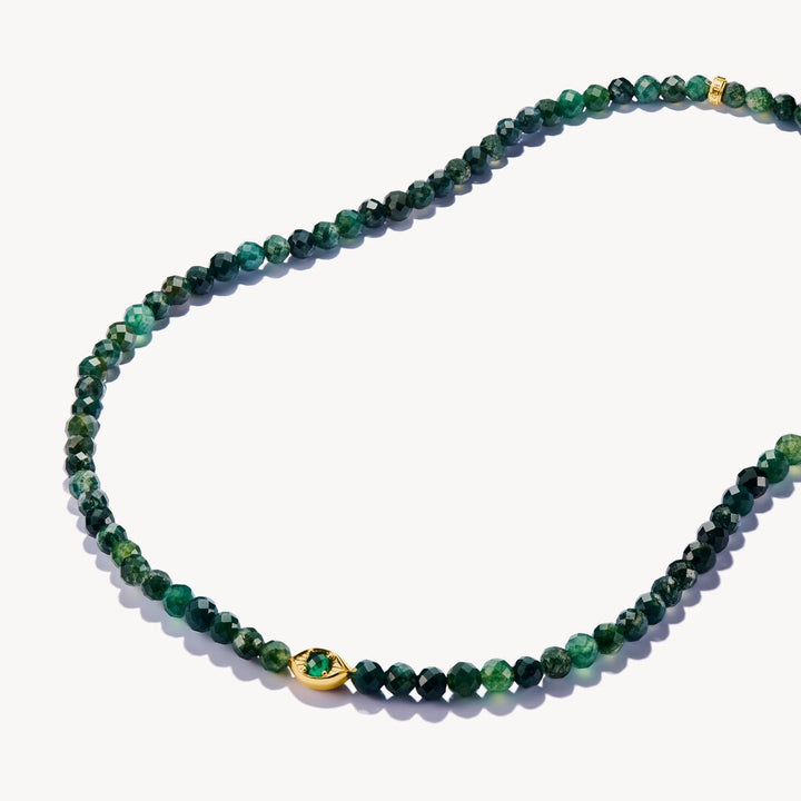 Green beaded necklace with a gold clasp on a white background