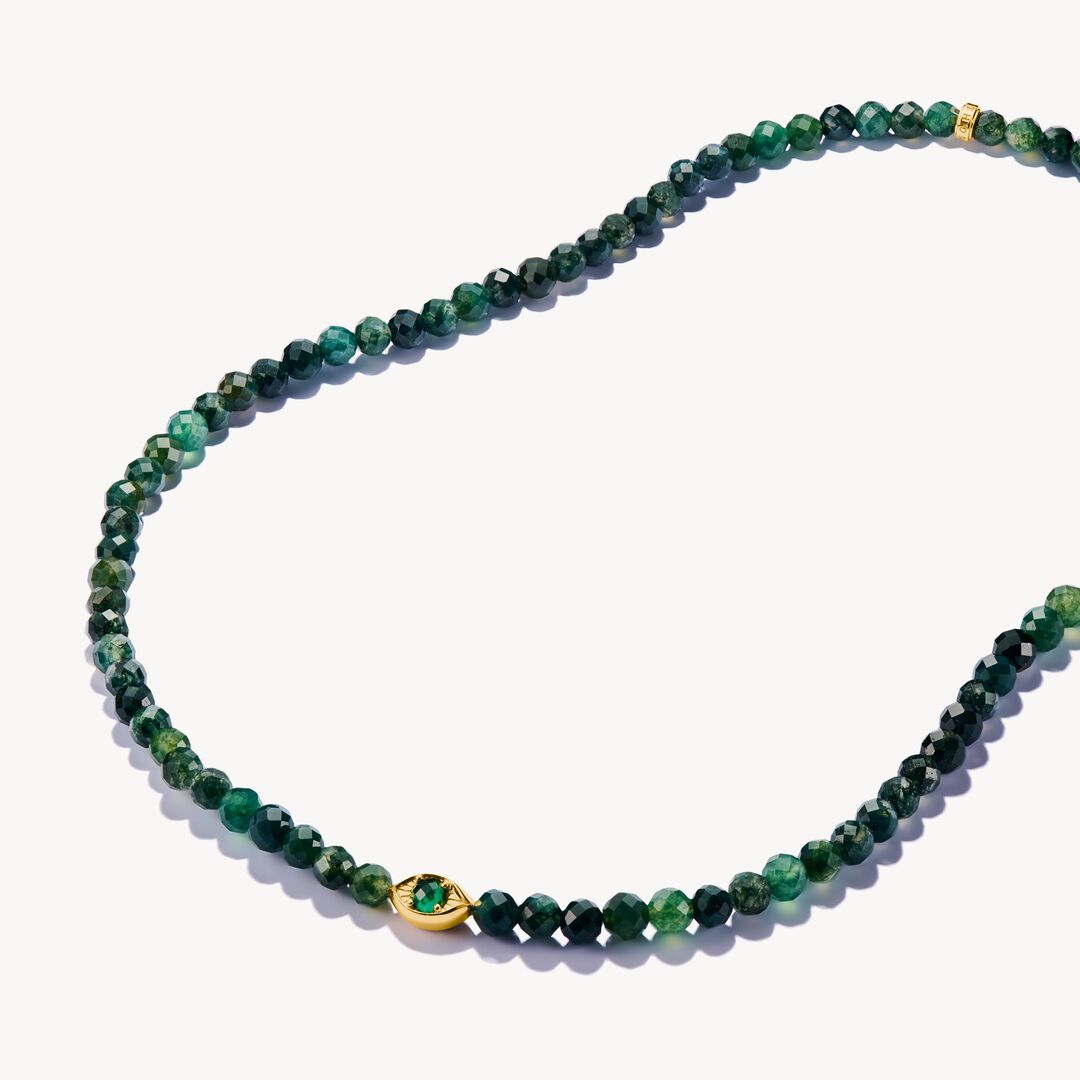 Green beaded necklace with a gold clasp on a white background