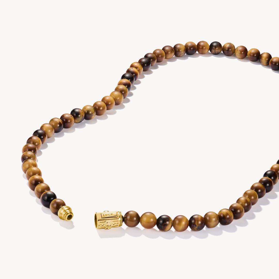 Beaded necklace with a gold clasp on a white background
