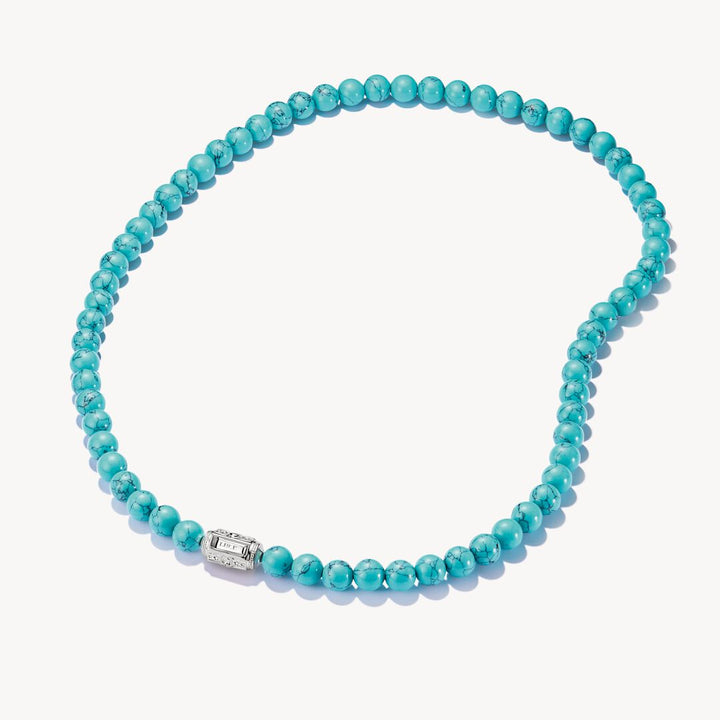 Turquoise beaded necklace with a silver clasp on a white background