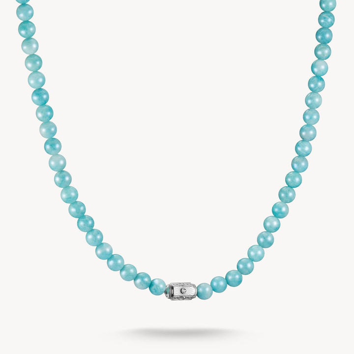 Turquoise beaded necklace with a silver clasp on a white background