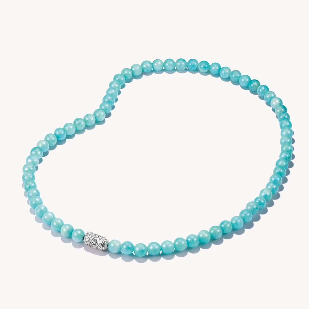 Turquoise beaded necklace with a silver clasp on a white background