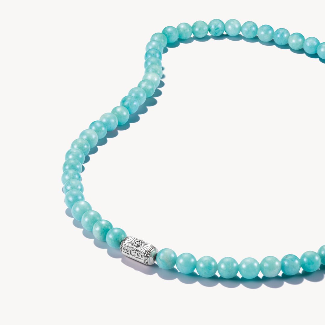 Turquoise beaded necklace with a silver clasp on a white background